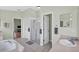 Ensuite bathroom features a soaking tub, glass enclosed shower, and dual sinks at 4531 Useppa Dr, Bradenton, FL 34203