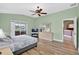 Light-filled bedroom features a ceiling fan, balcony access, and ensuite bath access at 4531 Useppa Dr, Bradenton, FL 34203