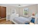 A bright bedroom with white furniture, ceiling fan, and outdoor view at 4531 Useppa Dr, Bradenton, FL 34203