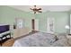 Relaxing bedroom features a ceiling fan, a dresser and ensuite bathroom access at 4531 Useppa Dr, Bradenton, FL 34203