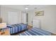 Well-lit bedroom is furnished with two twin beds, a dresser, and a closet at 4531 Useppa Dr, Bradenton, FL 34203