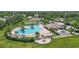 Aerial view of a community pool, tennis courts, and surrounding green space at 4531 Useppa Dr, Bradenton, FL 34203