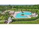An aerial shot of a community pool surrounded by lounge chairs and tropical landscaping at 4531 Useppa Dr, Bradenton, FL 34203