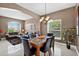 Open-concept dining area with a chandelier, large window and a view of the living room at 4531 Useppa Dr, Bradenton, FL 34203