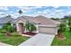 Inviting home with a neat front lawn, a wide driveway, and a two-car garage at 4531 Useppa Dr, Bradenton, FL 34203