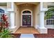 Inviting front entrance features a brick walkway, double doors, columns and lush landscaping at 4531 Useppa Dr, Bradenton, FL 34203