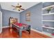Game room featuring a pool table, hardwood floors, and built-in shelves at 4531 Useppa Dr, Bradenton, FL 34203