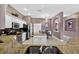 Open kitchen with stainless appliances, center island, granite counters, and a view into the adjacent dining area at 4531 Useppa Dr, Bradenton, FL 34203