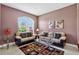 Comfortable living room features neutral colored walls, seating, and a decorative window at 4531 Useppa Dr, Bradenton, FL 34203