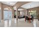 Open floor plan showcasing the living room, dining area, and decorative glass double doors at 4531 Useppa Dr, Bradenton, FL 34203