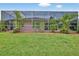 Screened-in lanai featuring tropical landscaping providing a private outdoor space at 4531 Useppa Dr, Bradenton, FL 34203