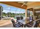 View of the shaded patio area with stylish patio furniture, ceiling fan and a view of the pool and lake at 4531 Useppa Dr, Bradenton, FL 34203