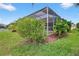 Enclosed patio with lush landscaping, perfect for relaxation and entertaining at 4531 Useppa Dr, Bradenton, FL 34203