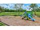 Community playground features swings, picnic tables, and playset with slides at 4531 Useppa Dr, Bradenton, FL 34203