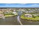 An aerial view showcasing a waterfront neighborhood and a boat sailing through the tranquil canal at 4727 Starboard Dr, Bradenton, FL 34208