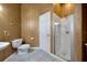 Charming bathroom featuring textured wallpaper, a pedestal sink, toilet, and a modern glass-enclosed shower at 4727 Starboard Dr, Bradenton, FL 34208