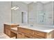 Bathroom featuring dual sinks, a large mirror, and a glass shower at 4727 Starboard Dr, Bradenton, FL 34208