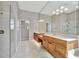 Bathroom with tile floors, dual sinks, and a glass shower at 4727 Starboard Dr, Bradenton, FL 34208