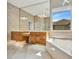 Bright bathroom featuring dual vanities, a large mirror, and a soaking tub with a view at 4727 Starboard Dr, Bradenton, FL 34208