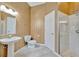 Bright bathroom with a vanity sink, toilet, and walk-in shower, accented by elegant wallpaper at 4727 Starboard Dr, Bradenton, FL 34208