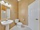 Stylish bathroom with a classic pedestal sink, toilet, and elegant mirror, complemented by a shower at 4727 Starboard Dr, Bradenton, FL 34208