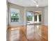 Sunlit bedroom with hardwood floors, large windows, and a sliding glass door to the pool area at 4727 Starboard Dr, Bradenton, FL 34208