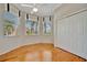 Bright bedroom featuring wood floors, multiple windows, ceiling fan, and a spacious closet at 4727 Starboard Dr, Bradenton, FL 34208