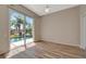 Bedroom featuring laminate wood flooring, ceiling fan, and glass sliding doors to lanai and pool at 4727 Starboard Dr, Bradenton, FL 34208