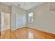 Bedroom with hardwood floors, neutral paint and trim, window with a view and a double door closet at 4727 Starboard Dr, Bradenton, FL 34208