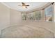 Well-lit bedroom with plush carpeting, crown molding, and large windows offering outdoor views at 4727 Starboard Dr, Bradenton, FL 34208