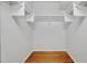 Walk-in closet with wooden floors and white shelving at 4727 Starboard Dr, Bradenton, FL 34208