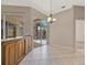 Dining area with a modern light fixture, tile flooring, and sliding glass doors overlooking the pool at 4727 Starboard Dr, Bradenton, FL 34208