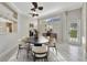 The dining room has an oval table, six chairs, a modern sideboard, and plenty of natural light at 4727 Starboard Dr, Bradenton, FL 34208