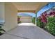 A covered driveway leads to a garage, surrounded by well-maintained landscaping and a clear blue sky at 4727 Starboard Dr, Bradenton, FL 34208