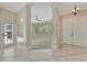 Inviting foyer with tile and carpet flooring, leading to a living area with natural light at 4727 Starboard Dr, Bradenton, FL 34208
