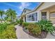 Beautifully landscaped home featuring lush garden beds and a curved walkway leading to the front door at 4727 Starboard Dr, Bradenton, FL 34208