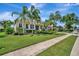 Inviting single-story home with lush front lawn, mature trees, and well-maintained landscaping at 4727 Starboard Dr, Bradenton, FL 34208