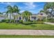 Charming single-story home with manicured lawn, mature landscaping, and a covered carport at 4727 Starboard Dr, Bradenton, FL 34208