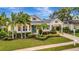 Charming home featuring lush landscaping, manicured lawn, and a covered carport at 4727 Starboard Dr, Bradenton, FL 34208