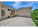 Attached garage with a wide driveway, complemented by lush greenery and a well-kept exterior at 4727 Starboard Dr, Bradenton, FL 34208