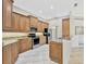 Well-lit kitchen featuring granite countertops, stainless steel appliances, and wood cabinetry at 4727 Starboard Dr, Bradenton, FL 34208