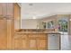 Kitchen island with granite countertops, stainless steel appliances and view of the pool at 4727 Starboard Dr, Bradenton, FL 34208