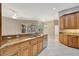 Open kitchen with granite countertops and stainless steel dishwasher overlooking the lanai and pool at 4727 Starboard Dr, Bradenton, FL 34208