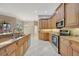 Elegant kitchen with granite countertops, wood cabinetry, and stainless steel appliances overlooking backyard at 4727 Starboard Dr, Bradenton, FL 34208