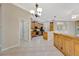 Kitchen area with stainless steel appliances, tile floors, wood cabinetry, and neutral walls at 4727 Starboard Dr, Bradenton, FL 34208