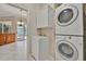 Laundry room with tile floors, stacked washer/dryer, and utility sink at 4727 Starboard Dr, Bradenton, FL 34208
