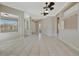 Spacious living area featuring neutral paint palette, tile flooring, and multiple ceiling fans at 4727 Starboard Dr, Bradenton, FL 34208