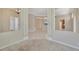 Spacious living area with tile flooring and neutral paint palette with columns defining the space at 4727 Starboard Dr, Bradenton, FL 34208