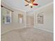 Comfortable living room with plush carpeting, crown molding, and natural light from large windows at 4727 Starboard Dr, Bradenton, FL 34208