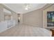 Bright living room with tile flooring, built-in shelving, and a sliding glass door to the lanai at 4727 Starboard Dr, Bradenton, FL 34208